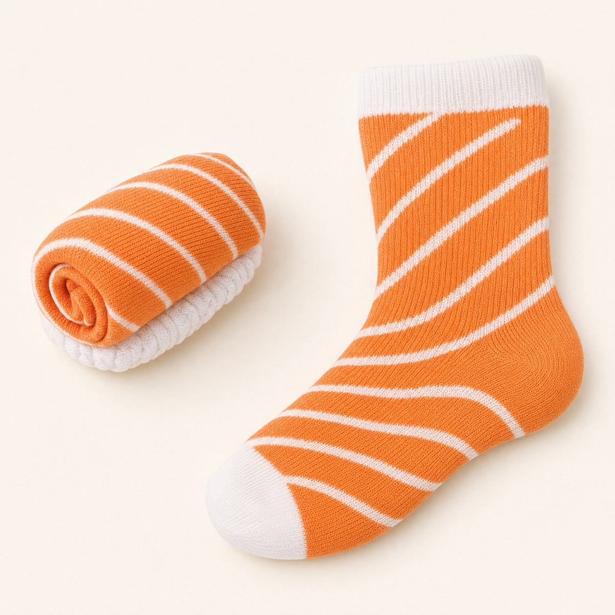 A sock rolled up like salmon nigiri next to the same sock half unrolled